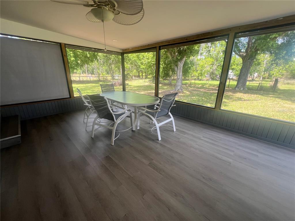 5855 Jack Brack Road St. Cloud, FL 34771 - Photo 79 of 86 a dining room with furniture and a floor to ceiling window