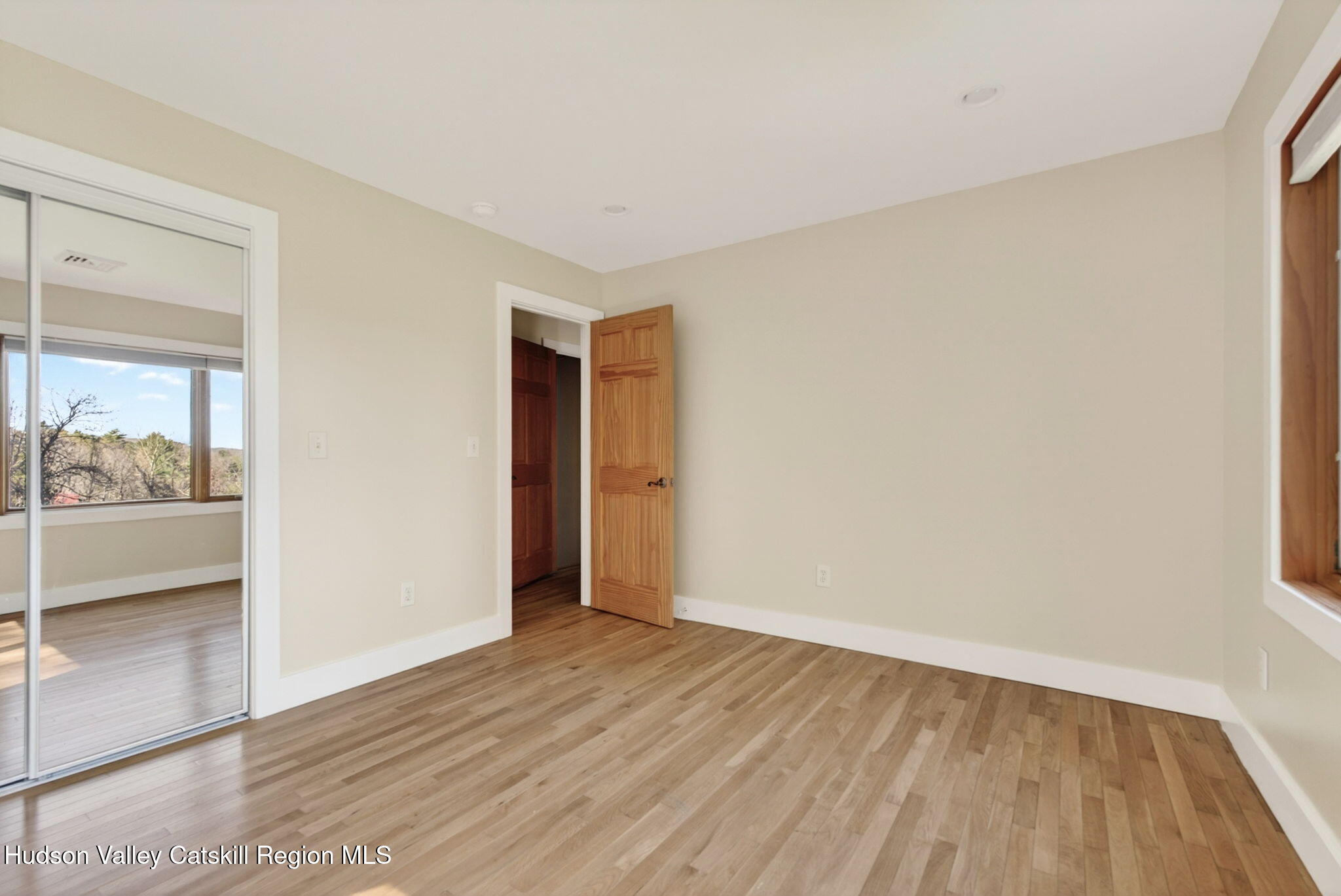86 Paul Horn Road Catskill, NY 12414 - Photo 34 of 56 an empty room with wooden floor and a door