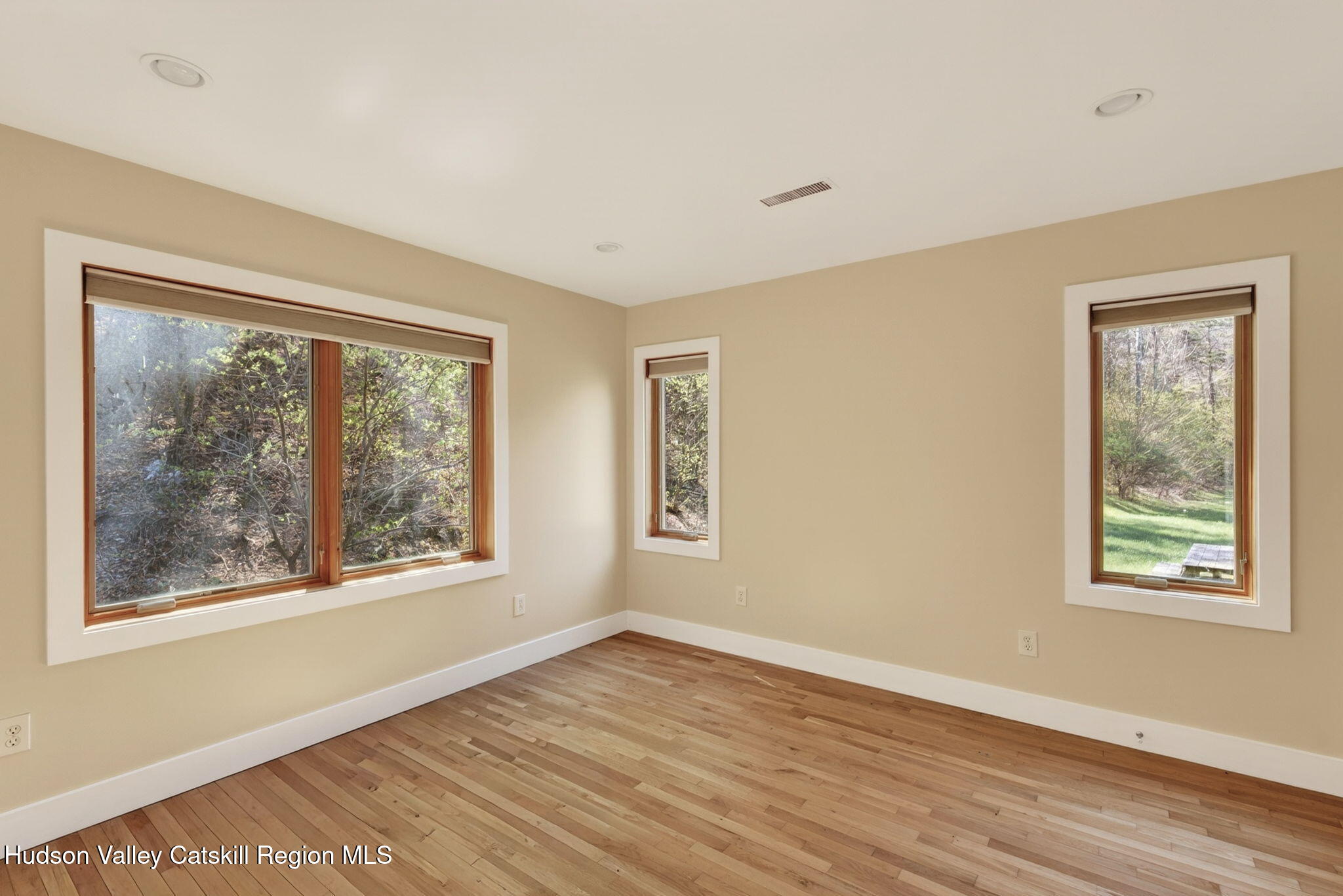 86 Paul Horn Road Catskill, NY 12414 - Photo 35 of 56 a view of an empty room with a window and wooden floor