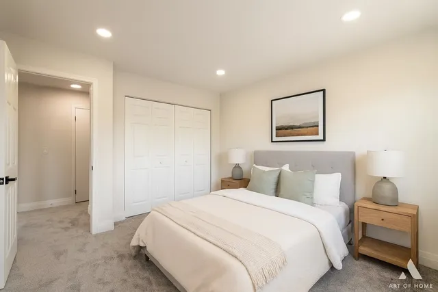 a bedroom with a bed and a painting