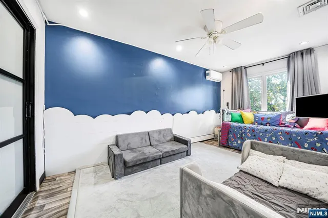 a bedroom with a bed and a television