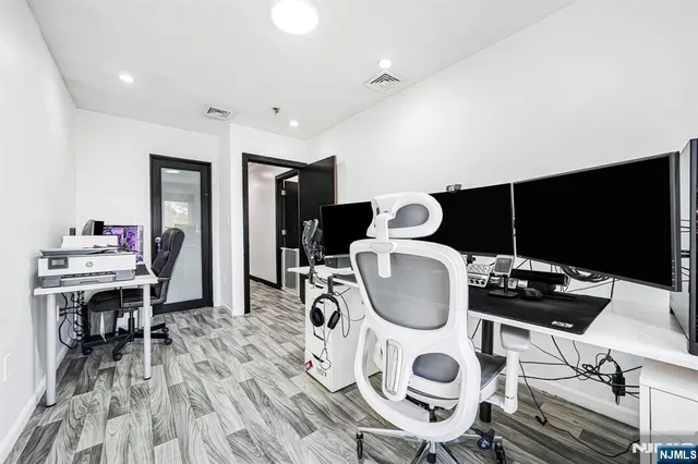 a view of a house with a yard and wooden fence