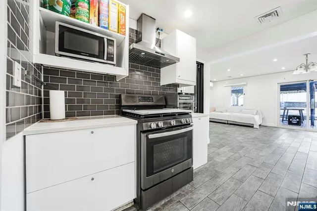 a view of kitchen with refrigerator and wooden floor