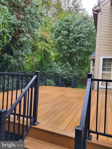 a view of balcony with wooden floor and fence