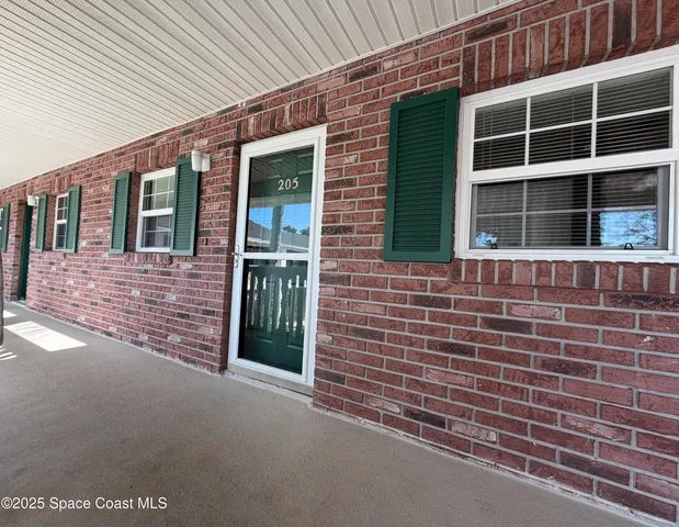 a view of a brick house with a large windows
