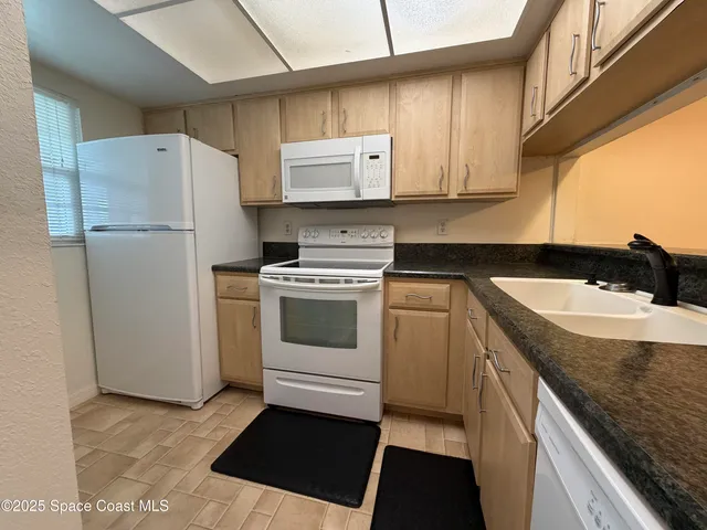 a kitchen with a sink stove and refrigerator