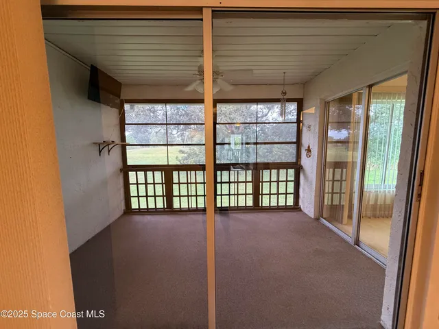 a view of an empty room with a balcony
