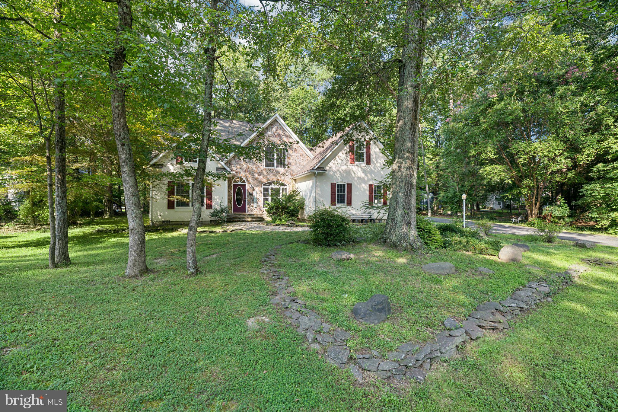a view of a house with a backyard and a tree