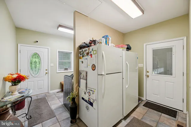 a white refrigerator freezer sitting in a kitchen