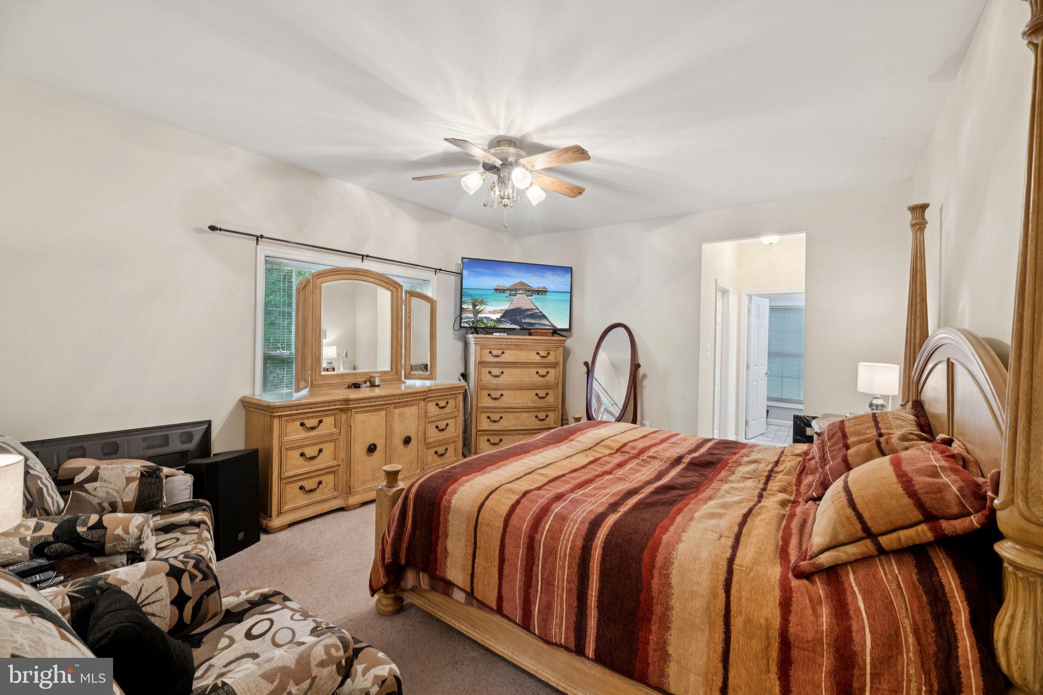 14715 Jennifer Court Issue, MD 20645 - Photo 29 of 43 a bedroom with a bed and dresser with mirror