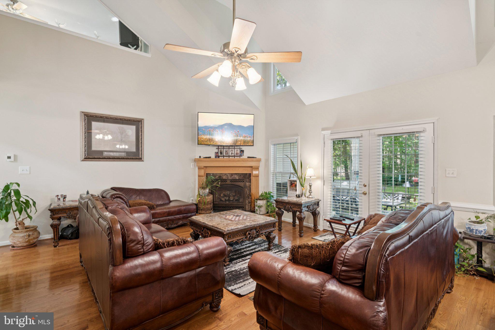 14715 Jennifer Court Issue, MD 20645 - Photo 7 of 43 a living room with furniture a fireplace and a chandelier