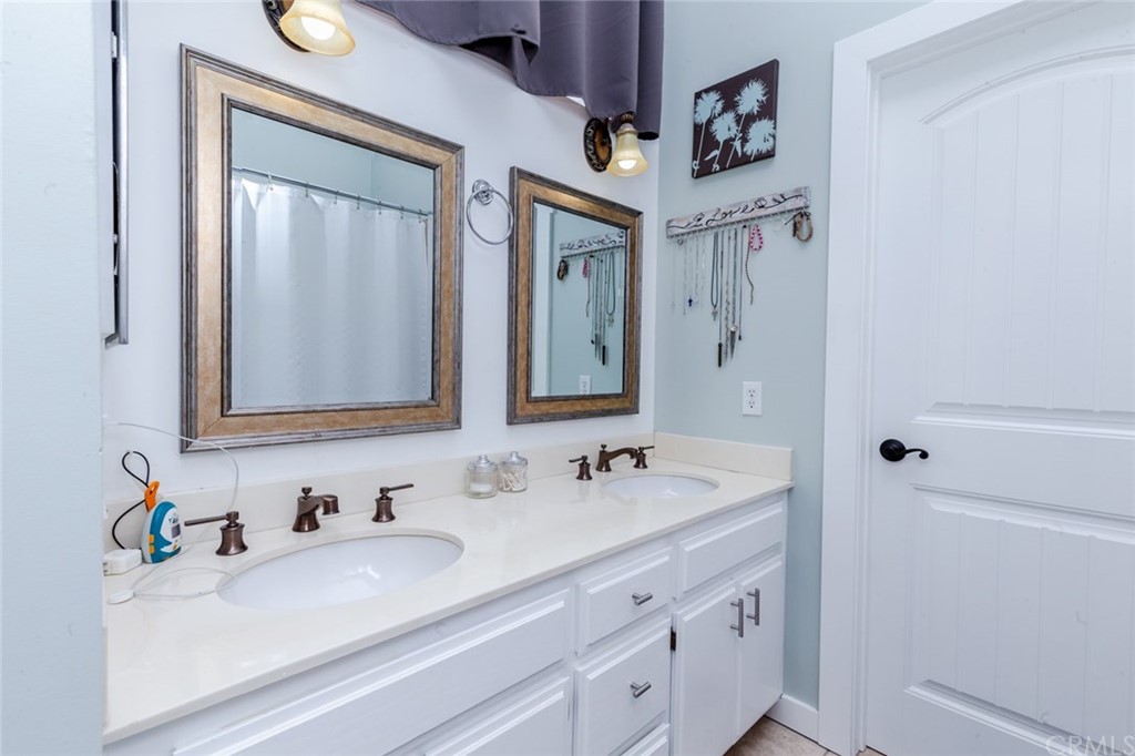 13058 Red Corral Drive Corona, CA 92883 - Photo 19 of 37 a bathroom with a sink vanity and a mirror
