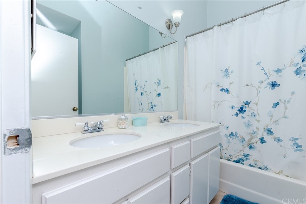 13058 Red Corral Drive Corona, CA 92883 - Photo 21 of 37 a bathroom with a sink and a mirror