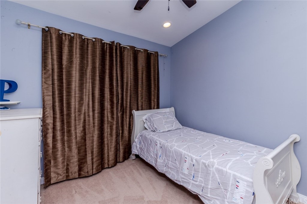 13058 Red Corral Drive Corona, CA 92883 - Photo 23 of 37 a bedroom with a bed and a window
