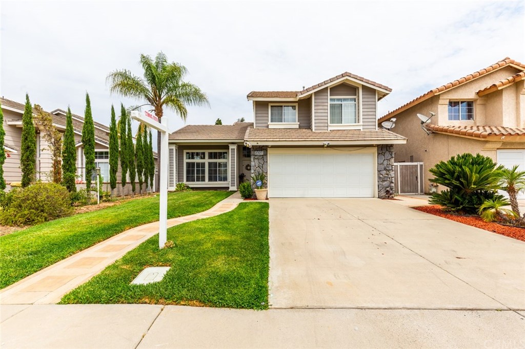 13058 Red Corral Drive Corona, CA 92883 - Photo 4 of 37 a front view of a house with a yard and trees
