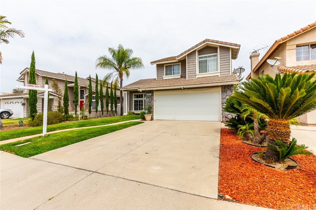 13058 Red Corral Drive Corona, CA 92883 - Photo 5 of 37 a front view of a house with a yard and garage