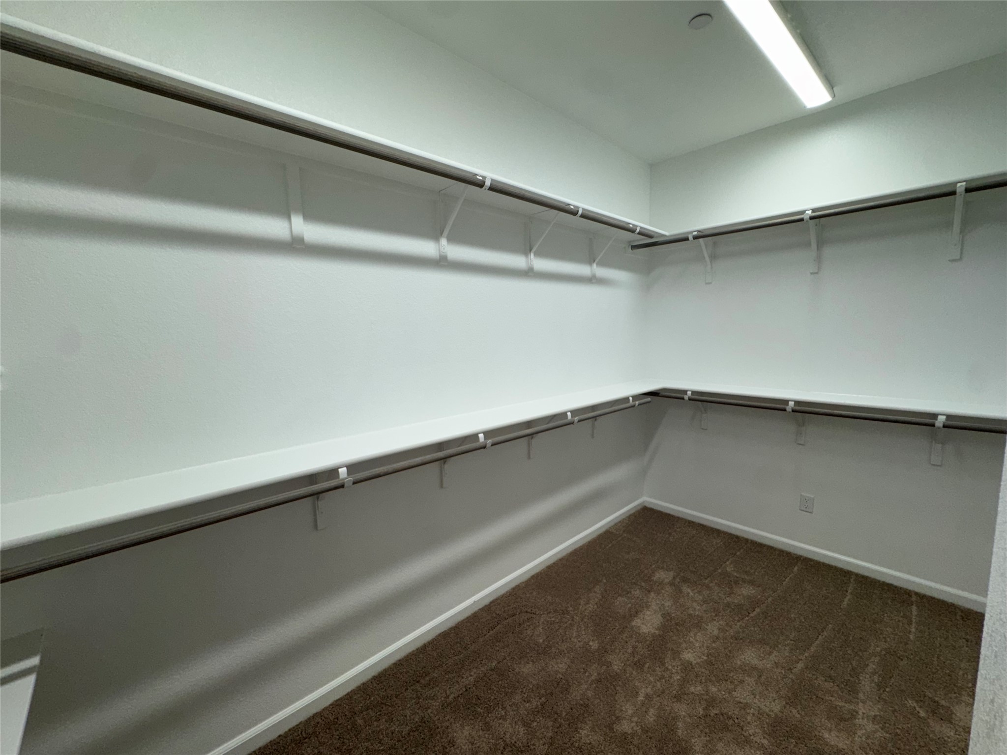 3000 Chisholm Trail Road, Unit 41 Round Rock, TX 78681 - Photo 14 of 28 Ample shelving and hanging rods create an organized and versatile wardrobe space.