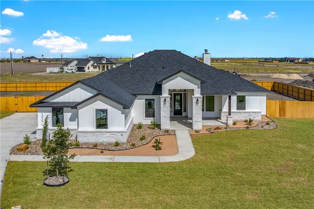 a front view of a house with swimming pool having outdoor seating