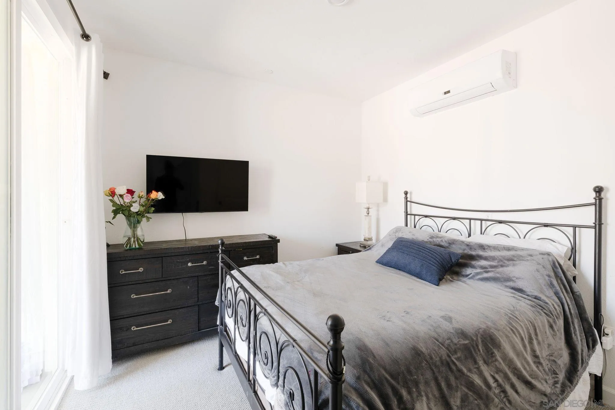 1983 Elevate Way Chula Vista, CA 91915 - Photo 35 of 39 a bedroom with a bed and a flat tv screen on dresser