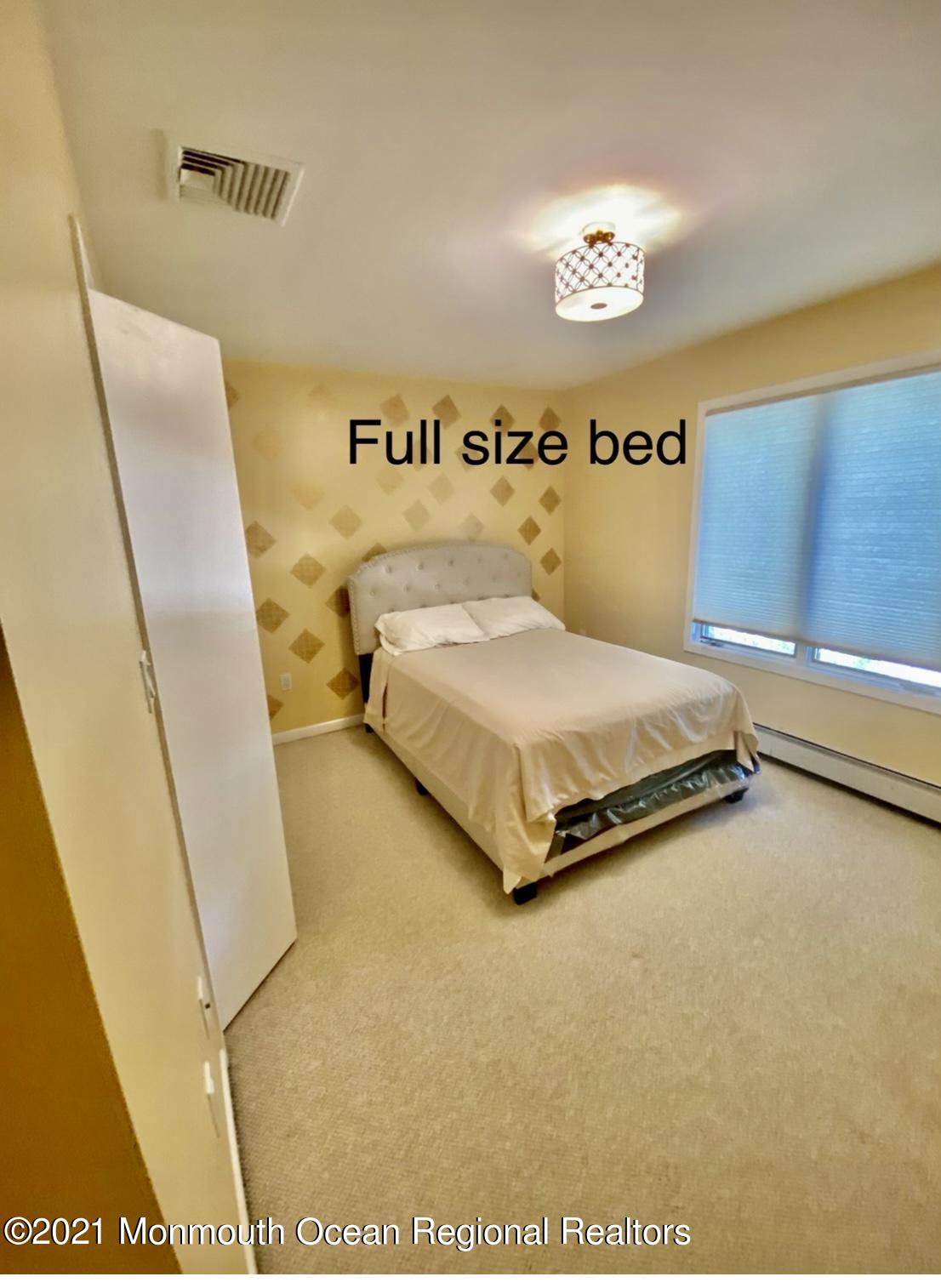 1706 Fanwood Street Oakhurst, NJ 07755 - Photo 15 of 26 a spacious bedroom with a bed and a table in it