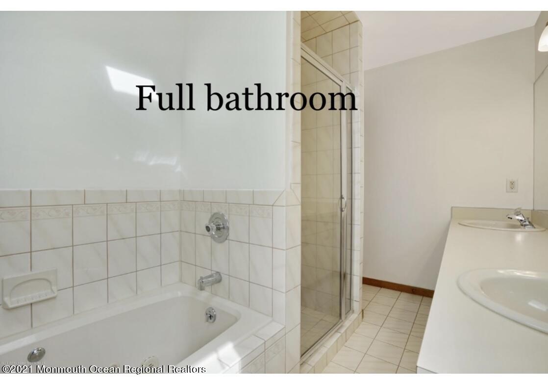 1706 Fanwood Street Oakhurst, NJ 07755 - Photo 18 of 26 a bathroom with a bathtub and shower