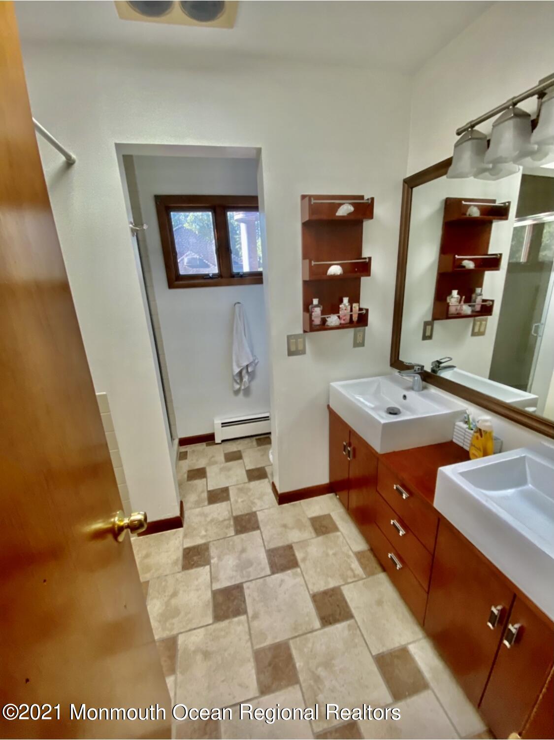 1706 Fanwood Street Oakhurst, NJ 07755 - Photo 22 of 26 a bathroom with a sink and a mirror