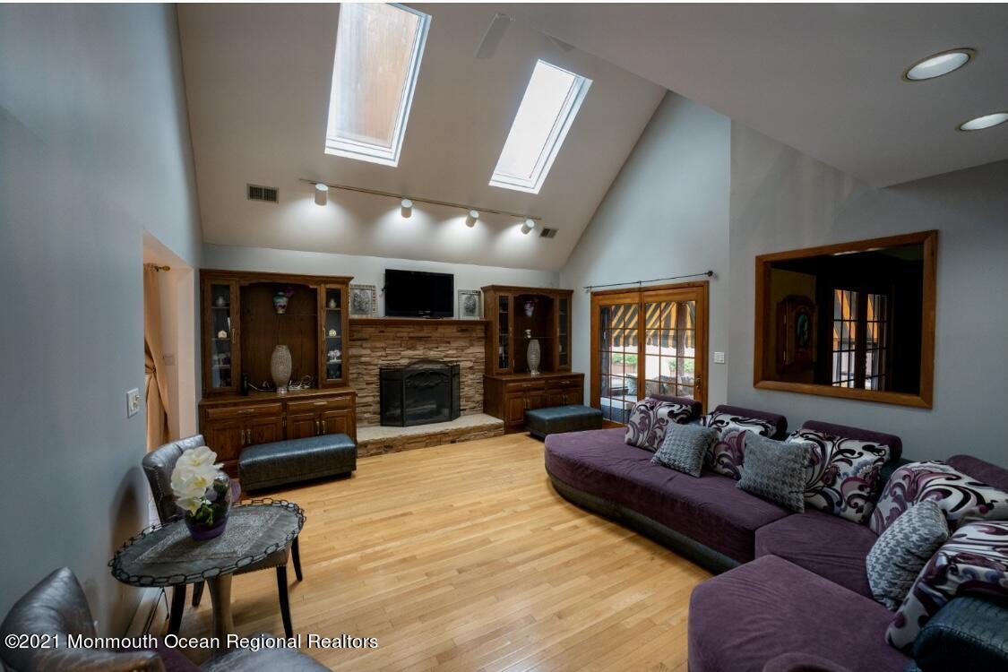 1706 Fanwood Street Oakhurst, NJ 07755 - Photo 8 of 26 a living room with furniture and a fireplace