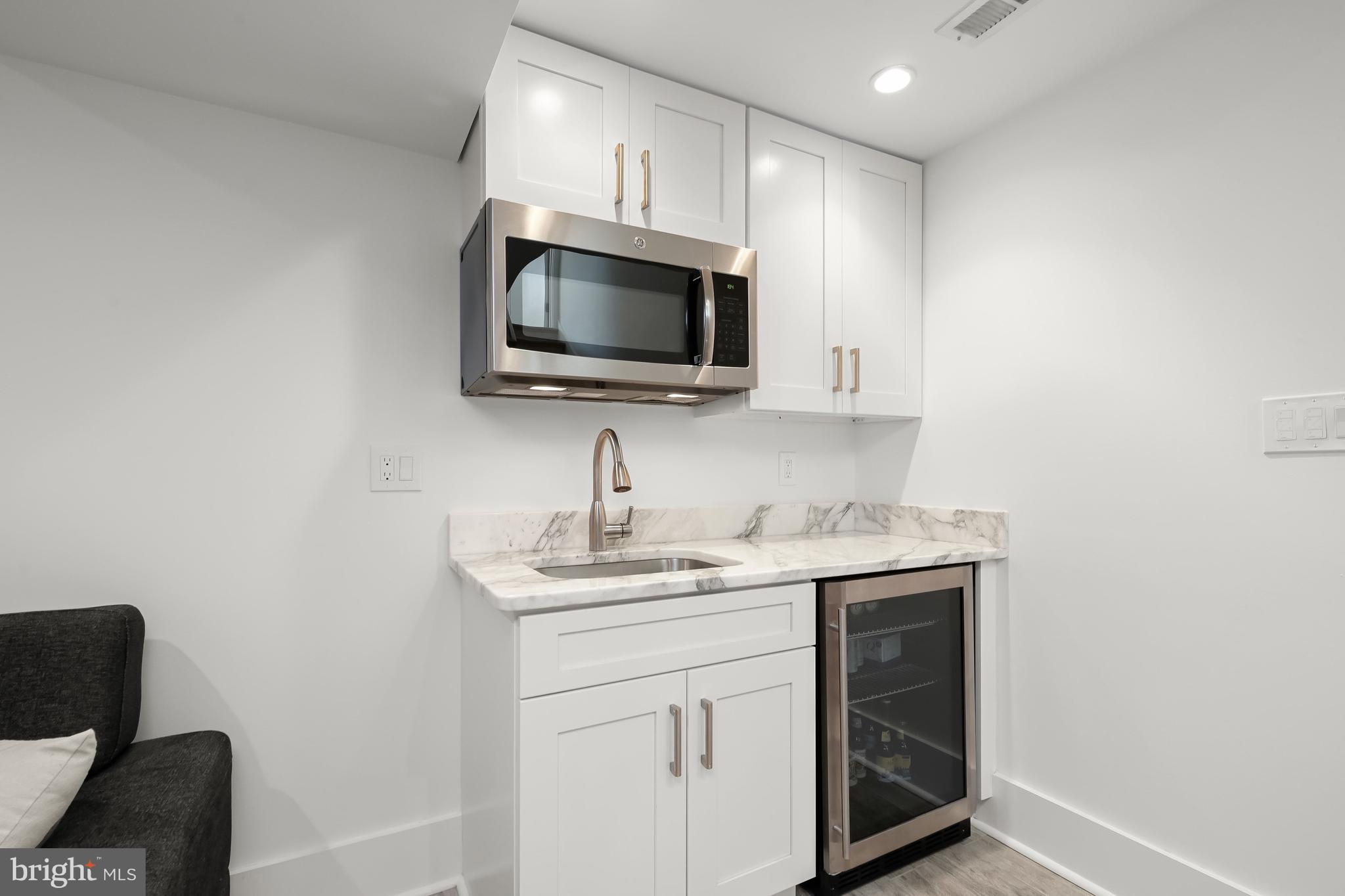 151 Uhland Terrace Northeast Washington, DC 20002 - Photo 18 of 21 Lower Level features wet bar with microwave