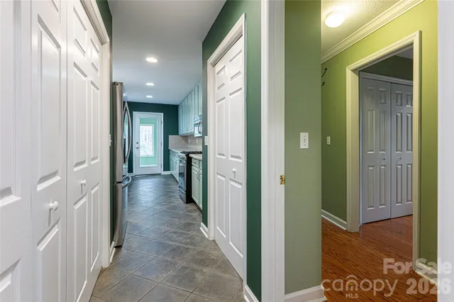 a view of a hallway with wooden floor and glass door
