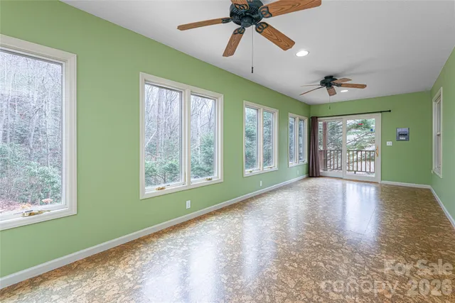 a view of an empty room with window and cabinet