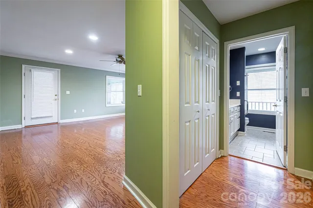 a view of a hallway with wooden floor