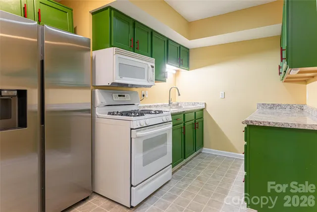 a kitchen with a sink cabinets and stainless steel appliances