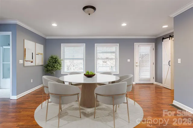 a view of a dining room with furniture window and wooden floor