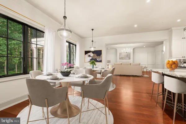 a view of an empty room with wooden floor cabinet and a window