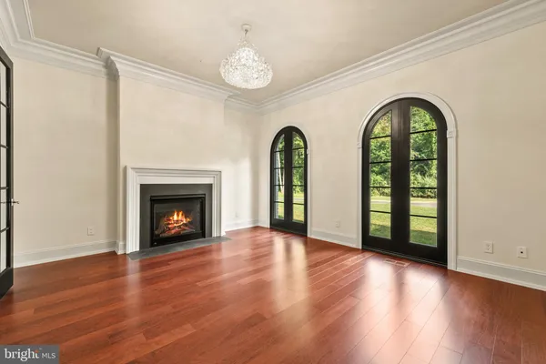 a view of an empty room with a fireplace and a large window