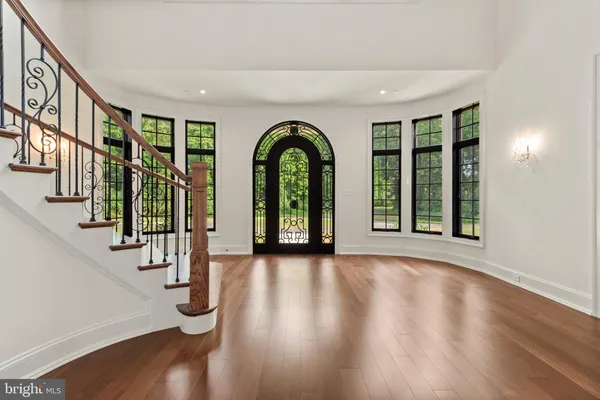 a view of empty room with wooden floor and windows