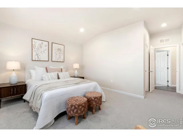 a bathroom with a granite countertop toilet a sink a mirror a vanity and shower