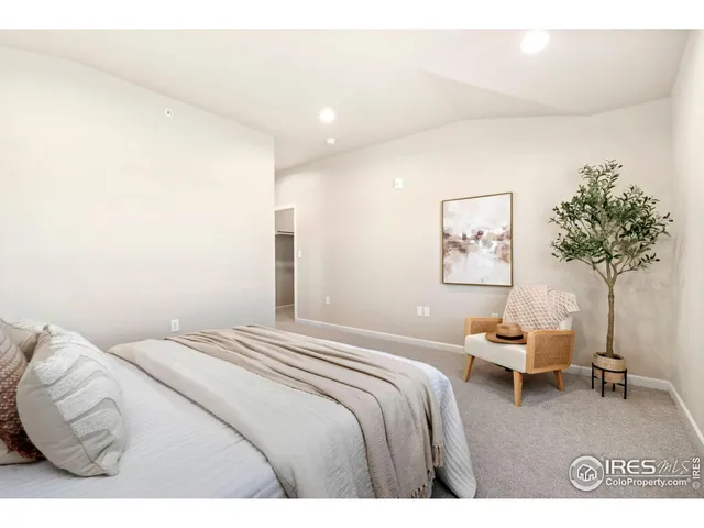a bathroom with a granite countertop bathtub sink vanity mirror and toilet