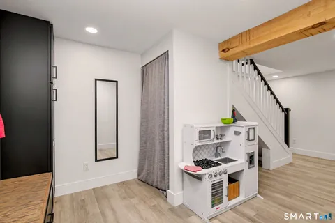 a bathroom with a granite countertop toilet sink and mirror