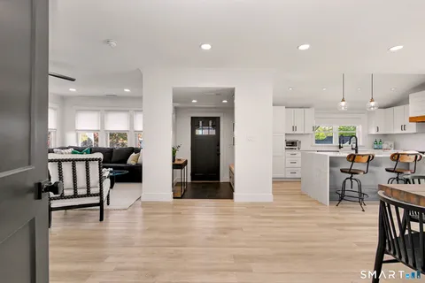 a living room with furniture wooden floor and a flat screen tv