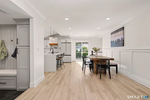 a kitchen with a sink a refrigerator and white cabinets