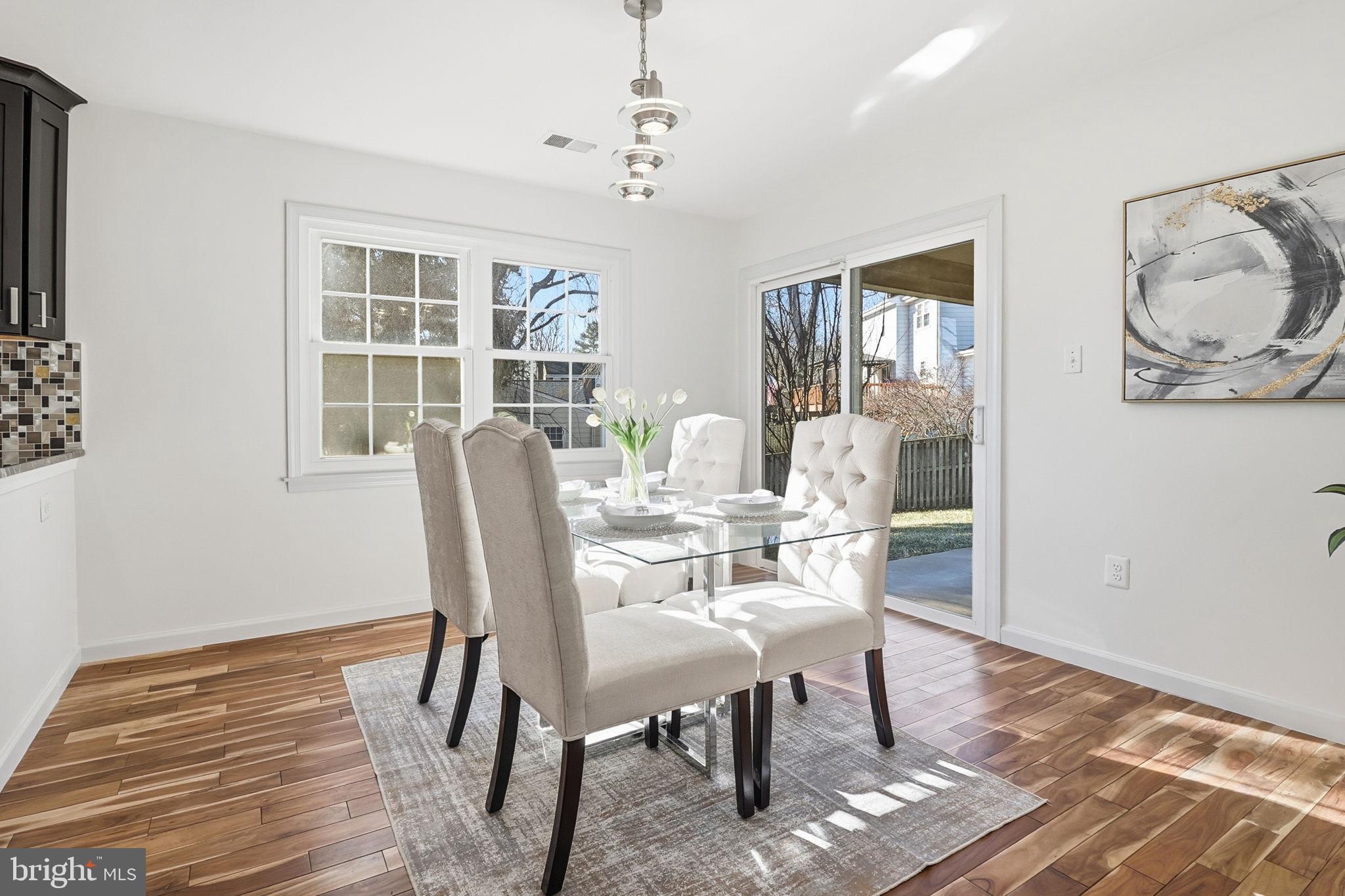 5207 Ruffner Woods Court Burke, VA 22015 - Photo 11 of 29 a view of a dining room with furniture window and wooden floor