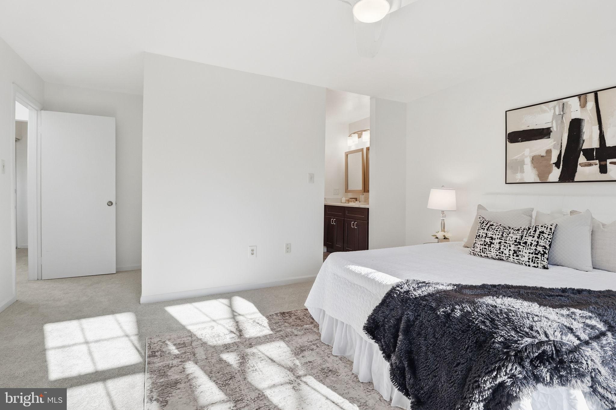 5207 Ruffner Woods Court Burke, VA 22015 - Photo 18 of 29 a bedroom with a bed and a painting on the wall