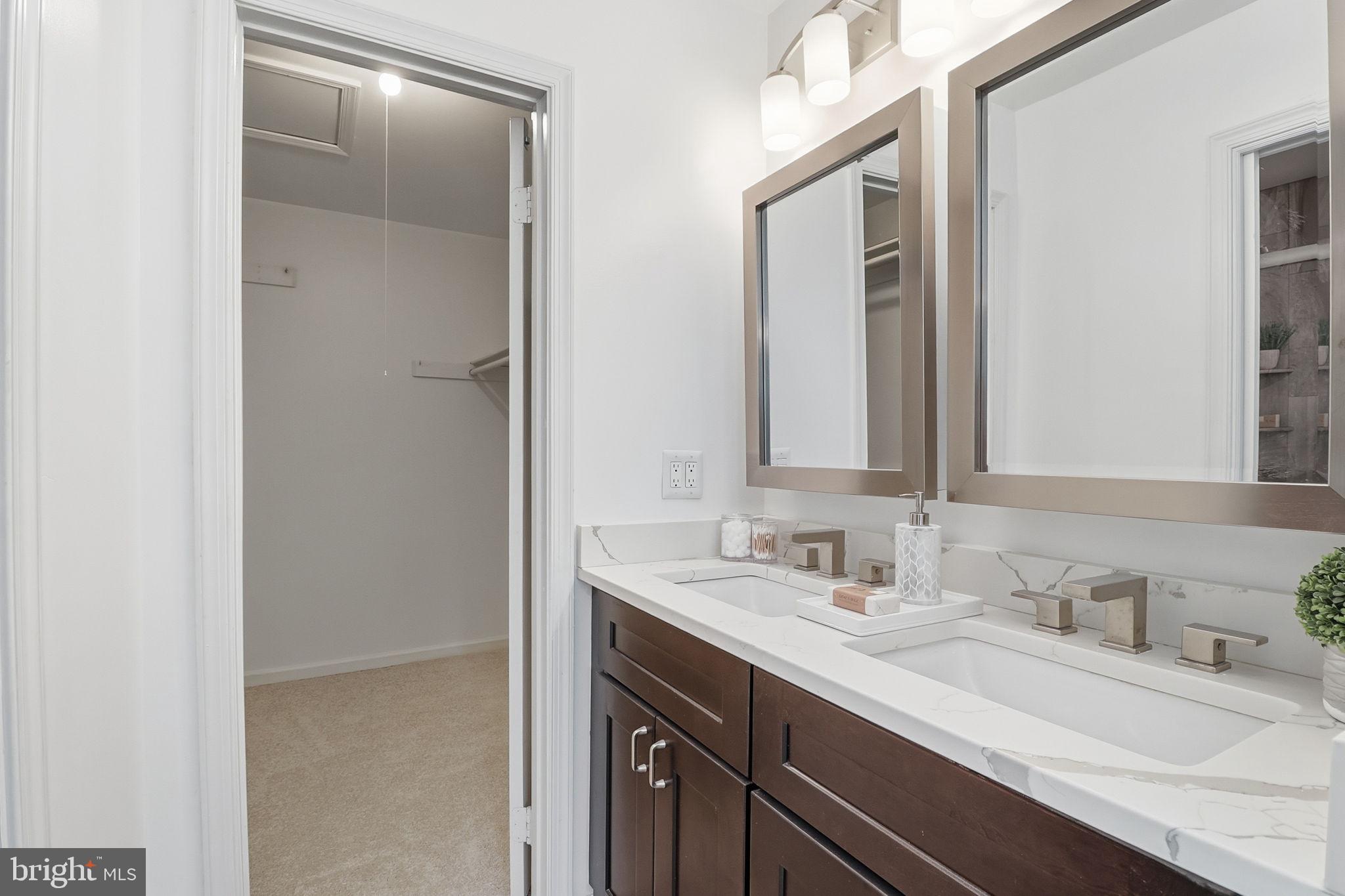 5207 Ruffner Woods Court Burke, VA 22015 - Photo 20 of 29 a bathroom with a double vanity sink and a mirror