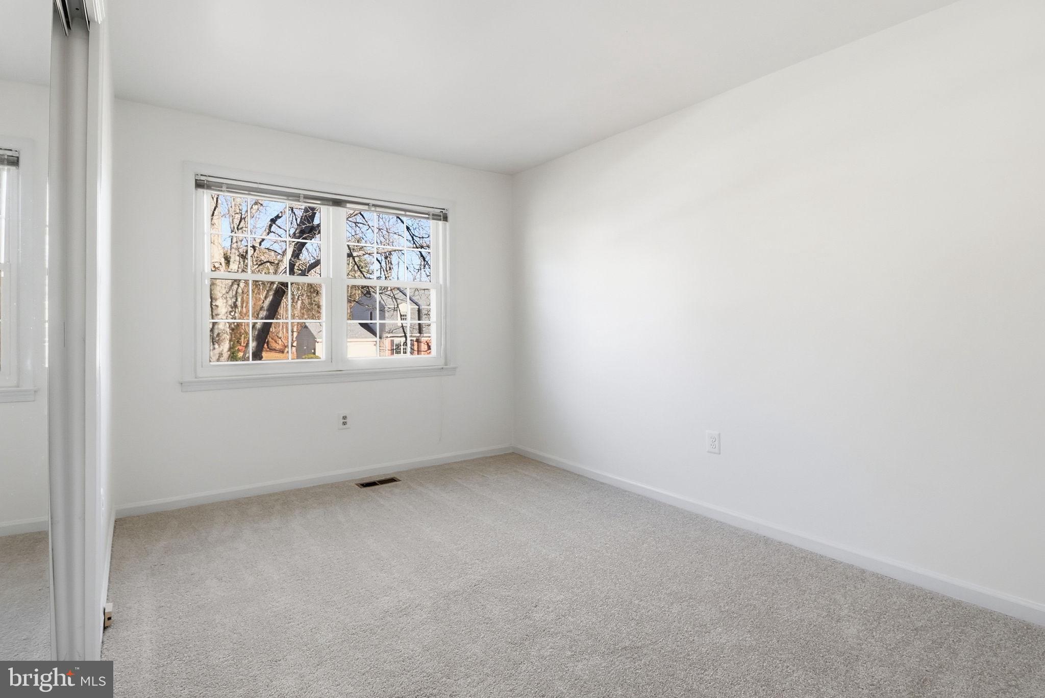 5207 Ruffner Woods Court Burke, VA 22015 - Photo 23 of 29 an empty room with windows