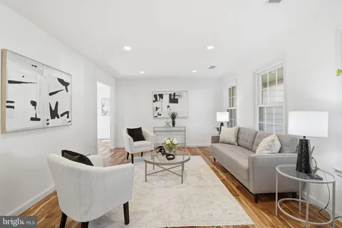 a living room with furniture and a lamp