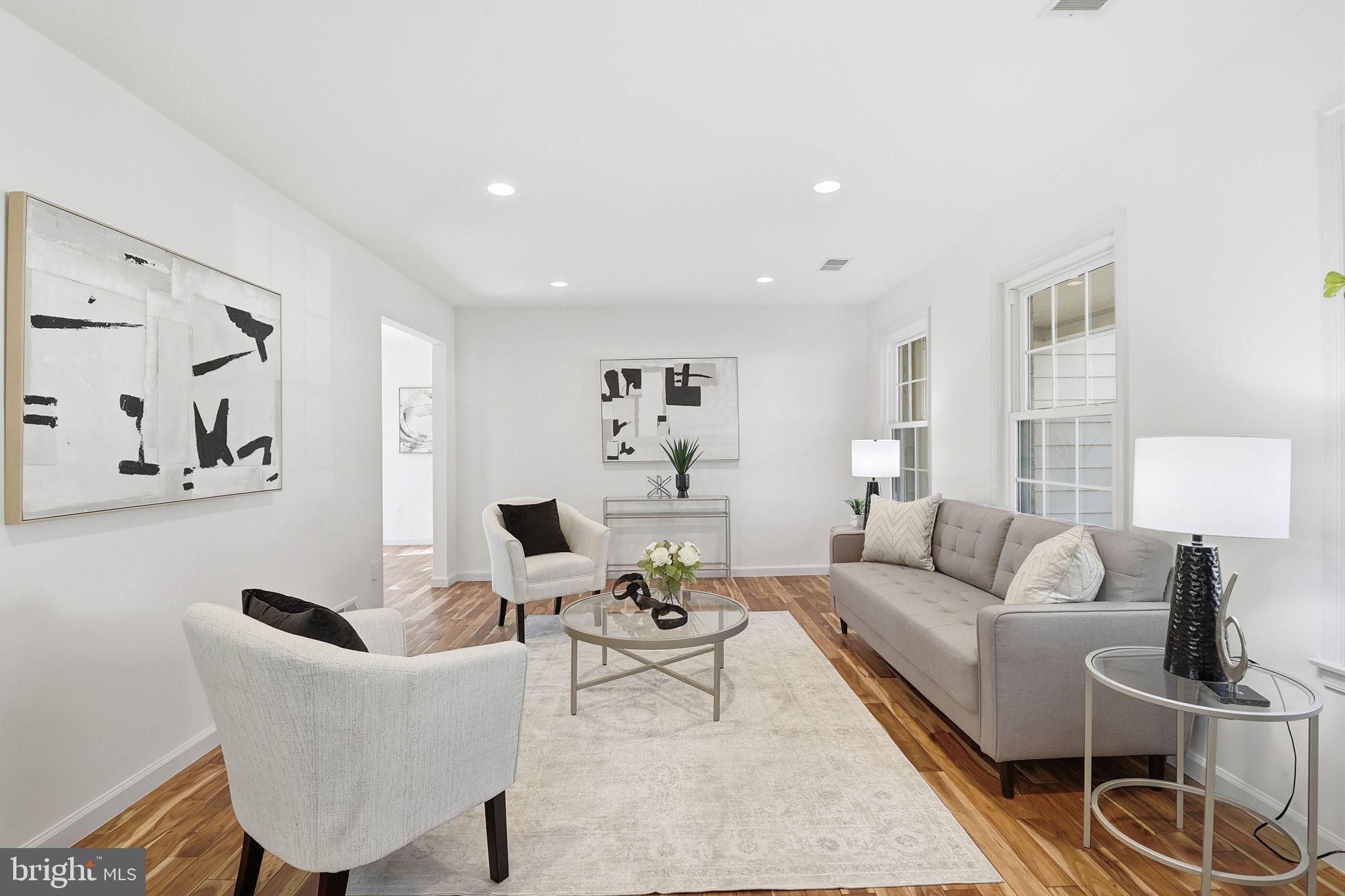 5207 Ruffner Woods Court Burke, VA 22015 - Photo 3 of 29 a living room with furniture and a lamp
