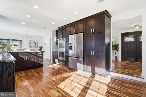 a kitchen with refrigerator and cabinets