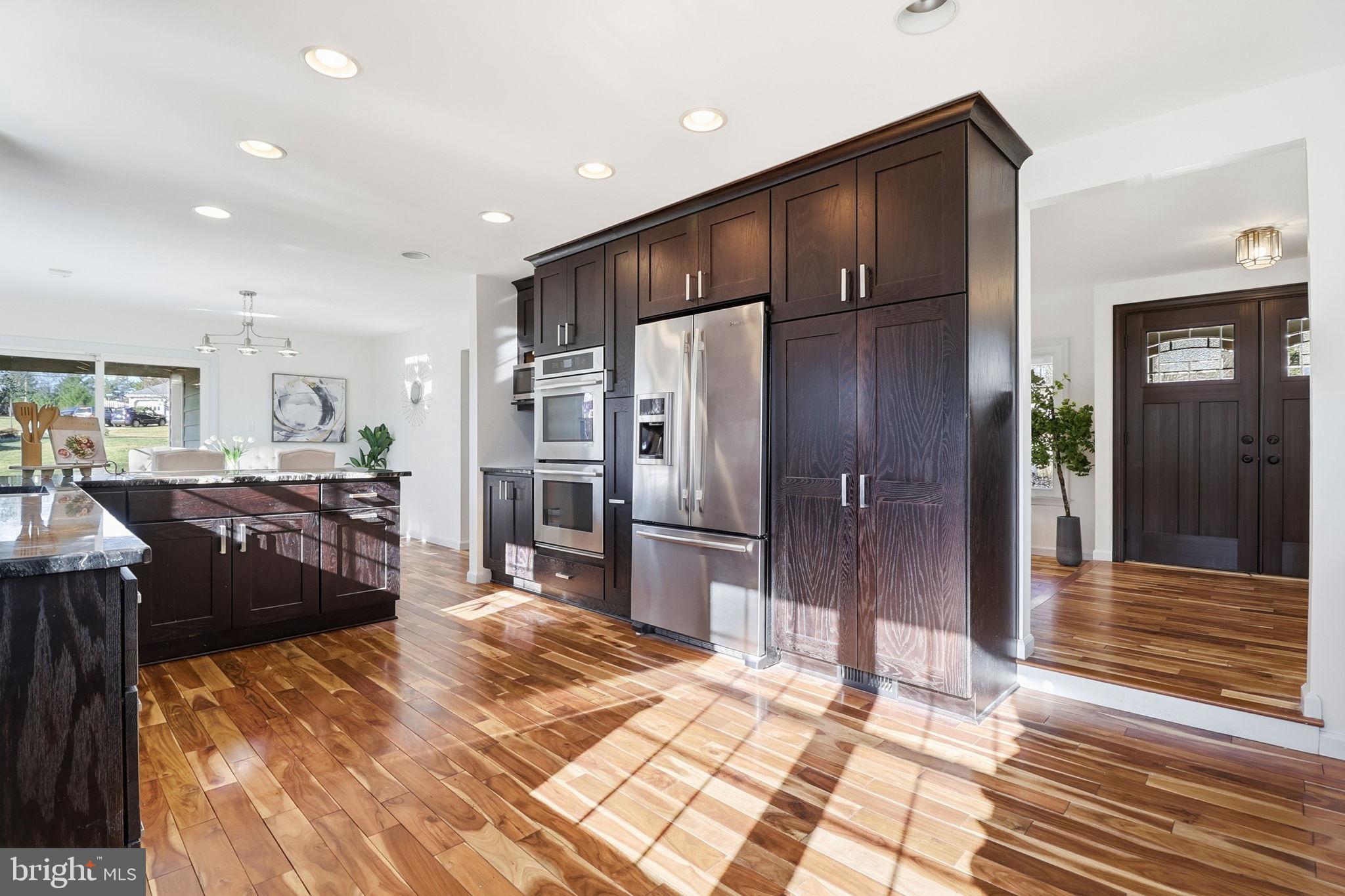5207 Ruffner Woods Court Burke, VA 22015 - Photo 6 of 29 a kitchen with refrigerator and cabinets
