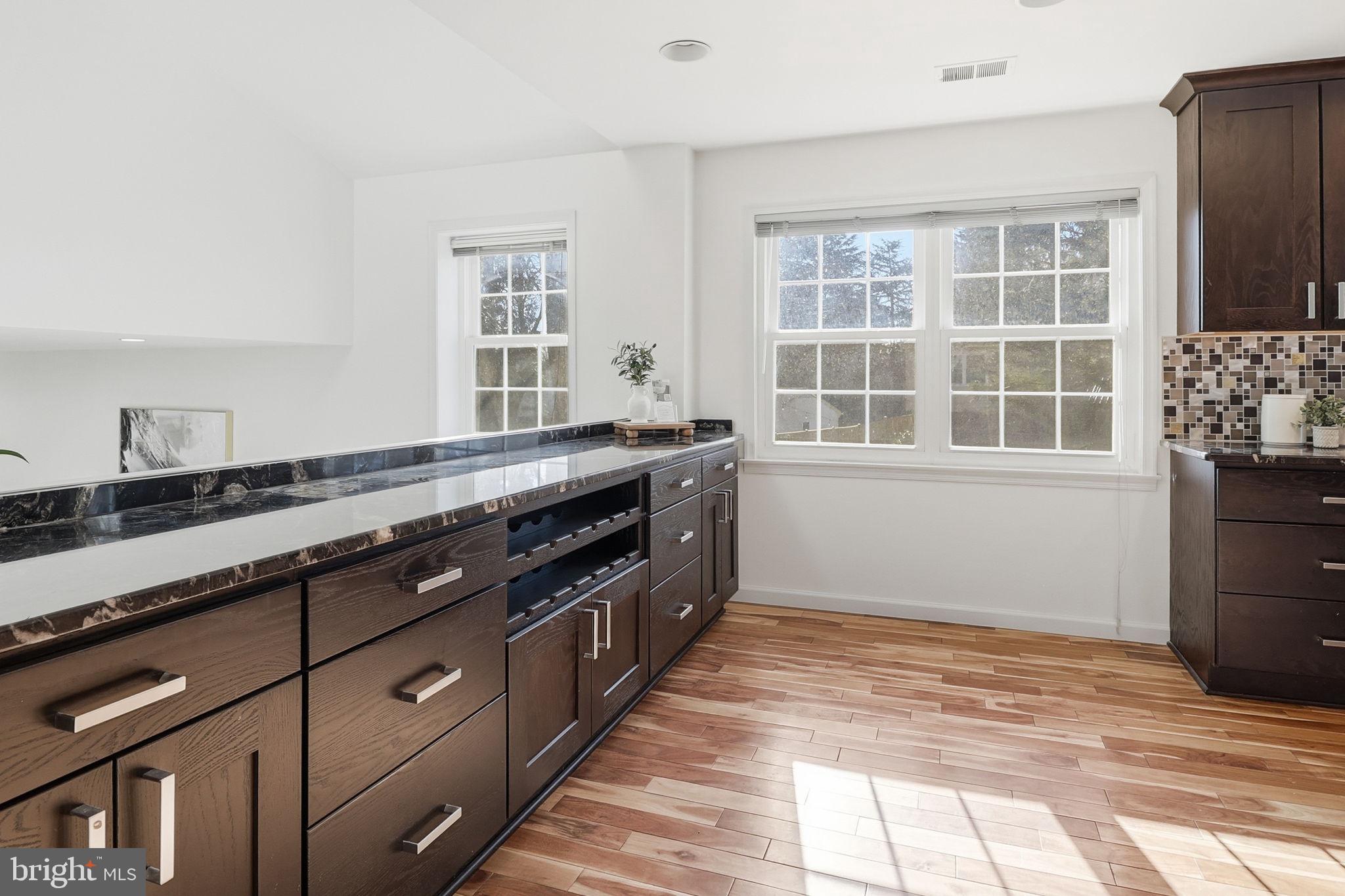5207 Ruffner Woods Court Burke, VA 22015 - Photo 7 of 29 a kitchen with granite countertop a stove and a sink